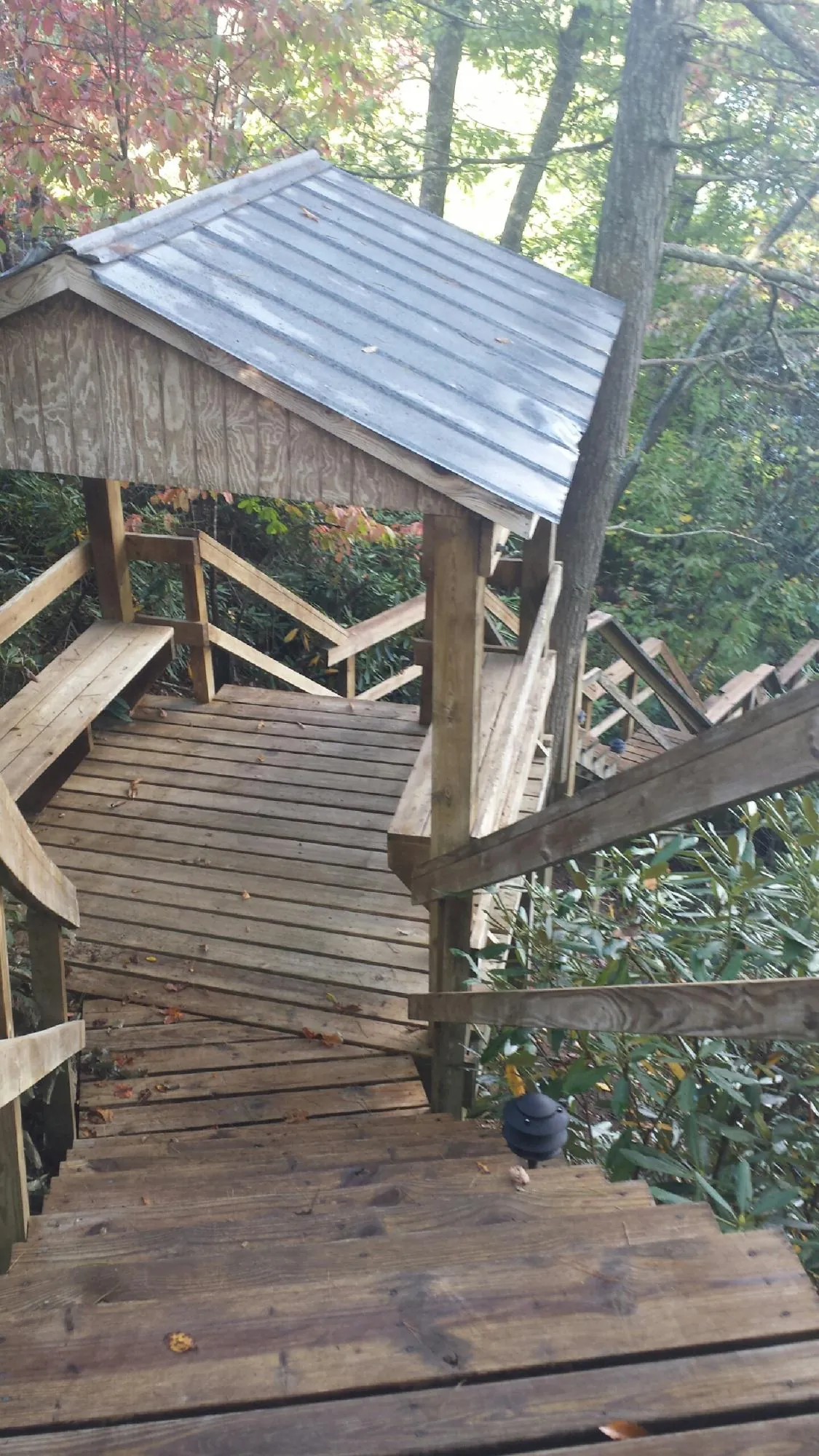 Metal roofed shelter over wooden steps on a wooded walkway — Skylight Repair & Installation work by our crew in East Weymouth